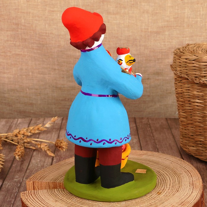 Дымковская игрушка "Мужик стоячий с уткой и утятами"