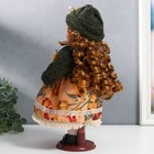 Кукла коллекционная керамика "Алёна в платье с цветами, в зелёной шапке и джемпере" 30 см - фото 3875249