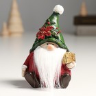 Сувенир полистоун "Дед Мороз в колпаке с пуансеттией, с подарком" 8,5х7,5х12 см - фото 319939179
